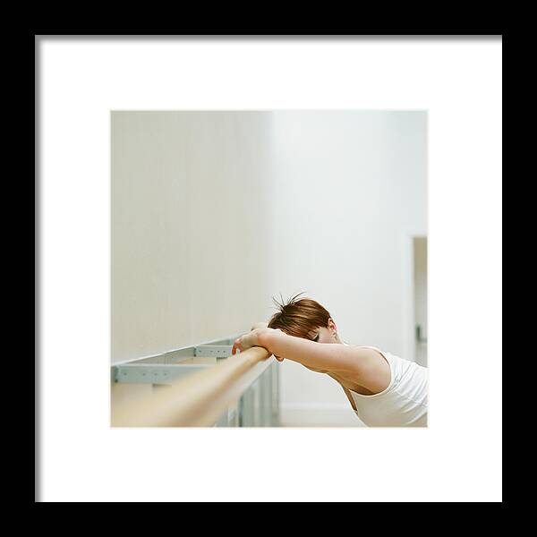 Casual Clothing Framed Print featuring the photograph Young Woman Leaning Against Rail In by Nick White