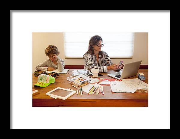 California Framed Print featuring the photograph Caucasian mother and son working at table #1 by Ronnie Kaufman