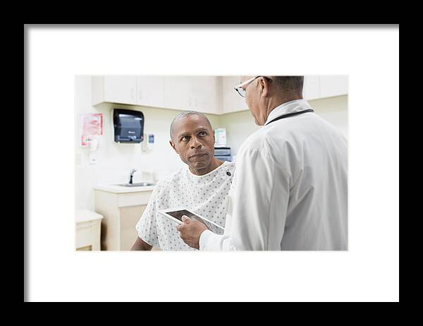 Expertise Framed Print featuring the photograph Doctor comforting patient in office #1 by Jose Luis Pelaez Inc