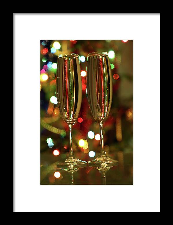 Champagne Framed Print featuring the photograph Glasses With Champagne Against Festive Lights #1 by Mikhail Kokhanchikov