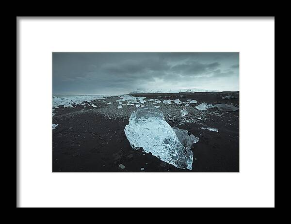 Glacier Lagoon Framed Print featuring the photograph Icebergs at sunset at Jökulsárlón Glacier lagoon on the black sand beach, Iceland. #1 by Daniel Viñé Garcia