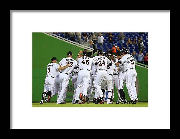 American League Baseball Framed Print featuring the photograph Marcell Ozuna by Mike Ehrmann