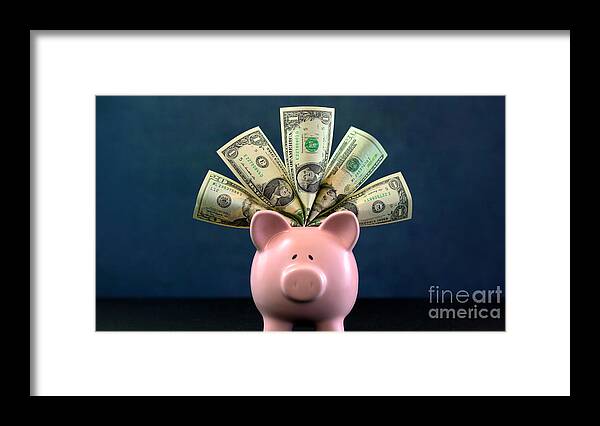 401k Framed Print featuring the photograph Pink Piggy bank money concept on dark blue background #1 by Milleflore Images