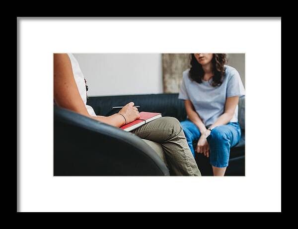 Expertise Framed Print featuring the photograph Psychotherapy session, woman talking to his psychologist in the studio #1 by Lorenzoantonucci