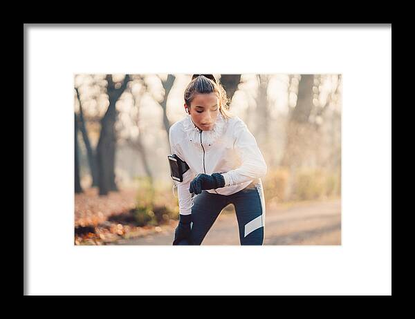 Bulgaria Framed Print featuring the photograph Sportswoman checking pulse #1 by Martin-dm