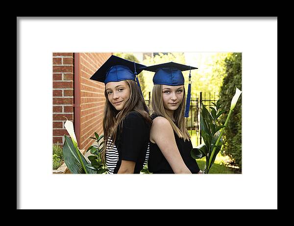 Education Framed Print featuring the photograph Teenage girls graduation from primary school portrait in backyard. #1 by Martinedoucet