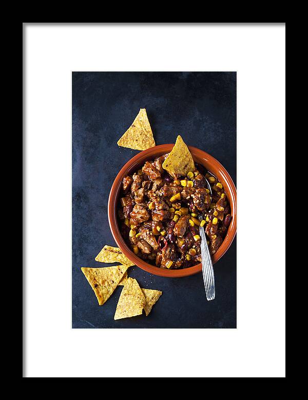 Spoon Framed Print featuring the photograph Vegetarian Chili with soy meat cut into strips and tortilla chips in earthenware dish #1 by Westend61