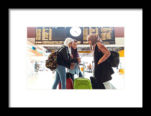 Three Quarter Length Framed Print featuring the photograph Young muslim women at train station leaving for a journey #1 by LeoPatrizi