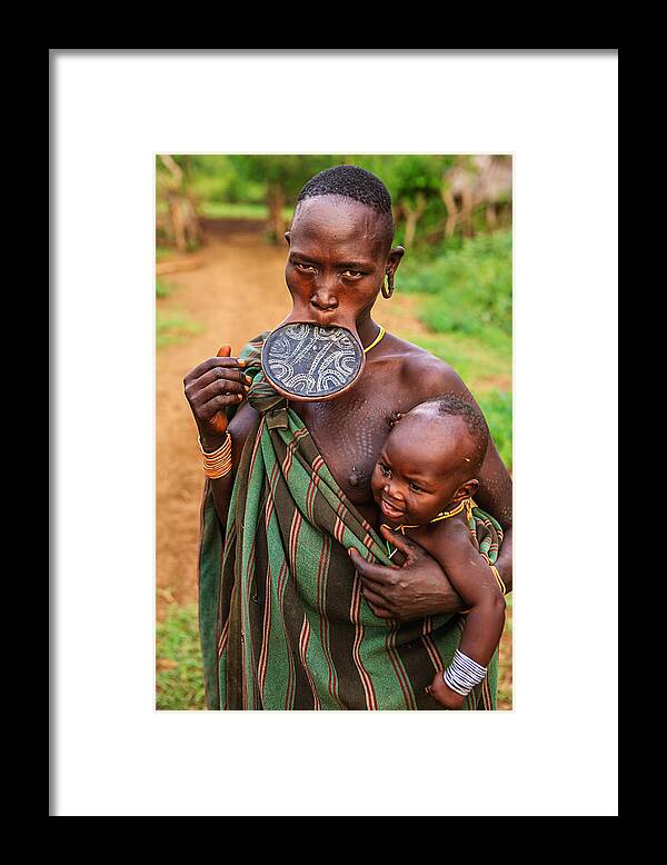 Vertical Framed Print featuring the photograph Portrait of woman from Mursi tribe, Ethiopia, Africa by Hadynyah