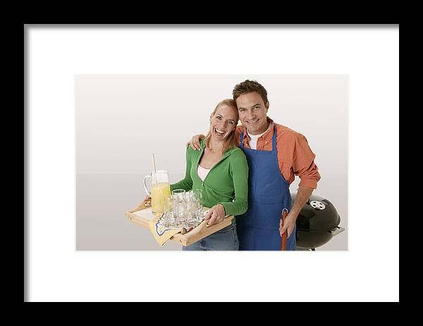 White People Framed Print featuring the photograph Couple at barbecue #2 by Comstock Images