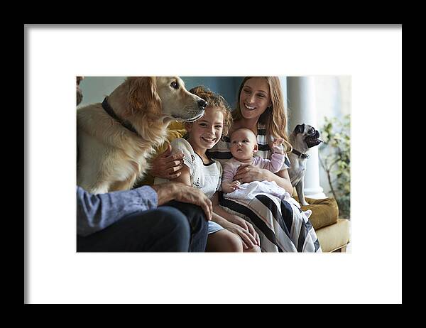 Pets Framed Print featuring the photograph Family sitting together in sofa with their dogs by Klaus Vedfelt
