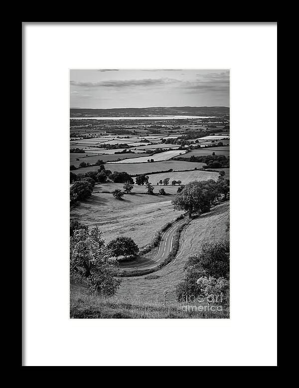 Britain Framed Print featuring the photograph Scenic Cotswolds - Patchwork fields, winding road #2 by Seeables Visual Arts