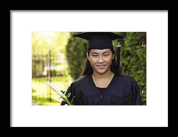 Asian And Indian Ethnicities Framed Print featuring the photograph Teenage girl graduation from primary school portrait in backyard. #2 by Martinedoucet
