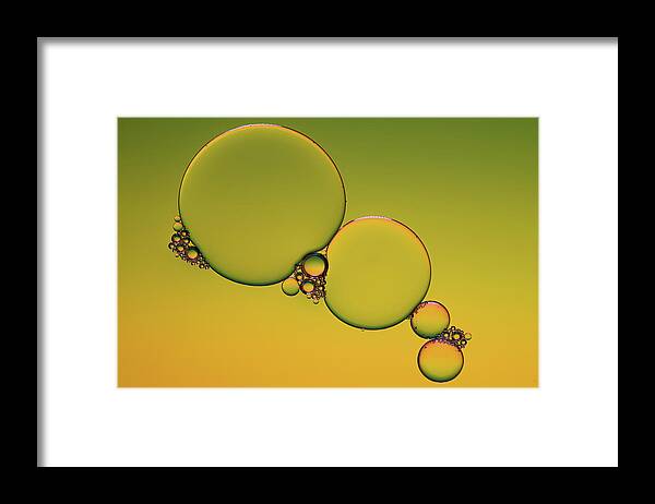 Connection Framed Print featuring the photograph Bright abstract, yellow background with flying bubbles by Michalakis Ppalis