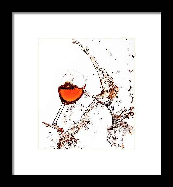 Damaged Framed Print featuring the photograph Broken wine glasses with wine splashes on a white background by Michalakis Ppalis