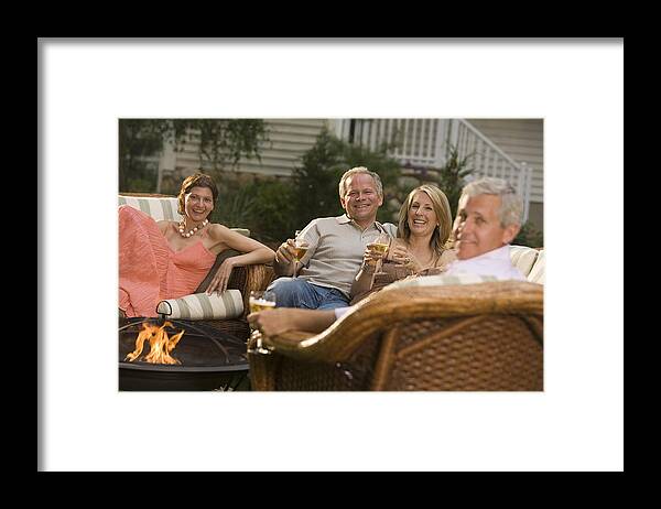 Mid Adult Framed Print featuring the photograph Friends conversing at a party #3 by Comstock Images