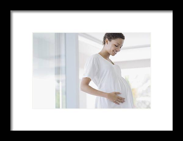 People Framed Print featuring the photograph Pregnant woman holding stomach by Sam Edwards