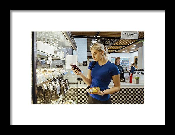 People Framed Print featuring the photograph Purchasing Healthy Refreshments #3 by SolStock