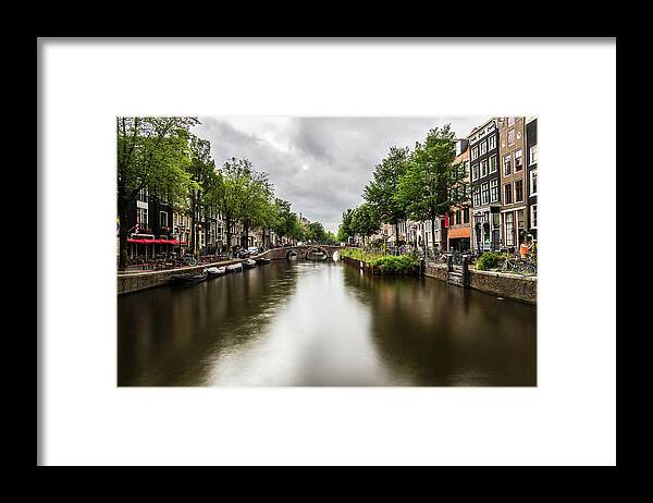 Canal Framed Print featuring the photograph Water canal in Amsterdam #3 by Fabiano Di Paolo