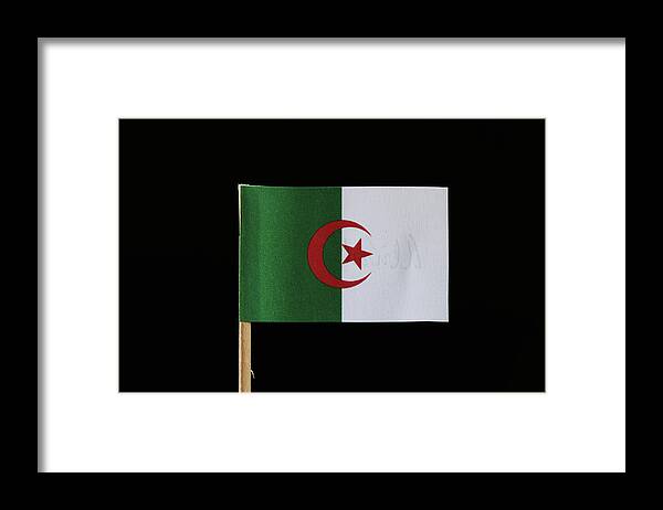 Algeria Framed Print featuring the photograph A original and official flag of Algeria on toothpick on black background. Consists of two equal vertical bars, green and white with a red star and crescent by Vaclav Sonnek