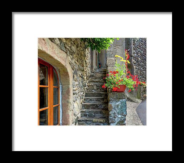 France Framed Print featuring the photograph A Peek of Life in Yvoire, France by Marcy Wielfaert