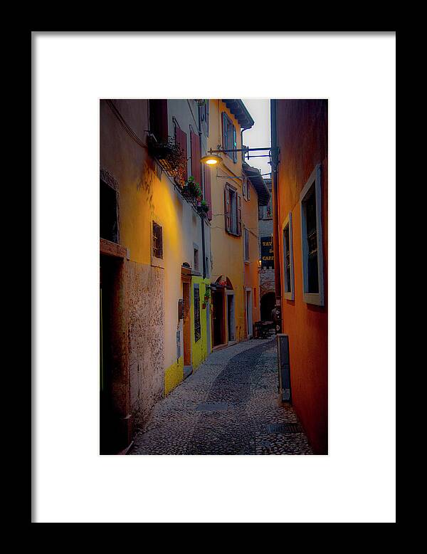 Tourism Framed Print featuring the photograph A Quiet Stroll in Malcesine by W Chris Fooshee