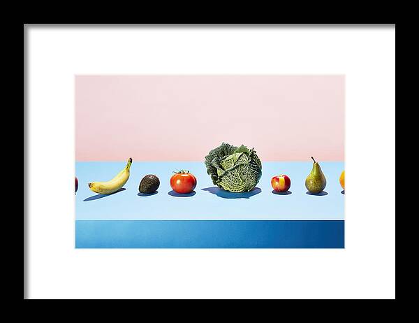 Diversity Framed Print featuring the photograph A row of different fruits and vegetables on a table top by Richard Drury