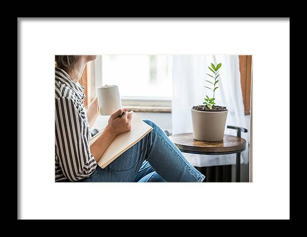 Tranquility Framed Print featuring the photograph A young woman taking a break from technology by MundusImages