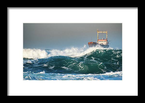 Shipwreck Framed Print featuring the photograph Abandoned ship in the stormy ocean by Michalakis Ppalis