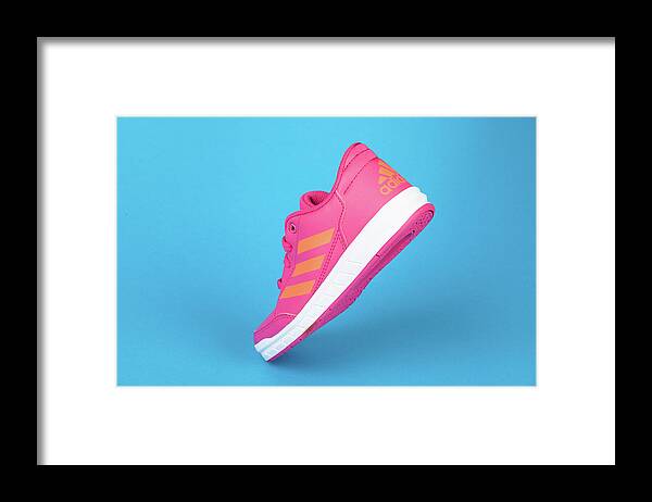 Adidas Framed Print featuring the photograph ADIDAS pink shoe, on blue background by Michael Dechev