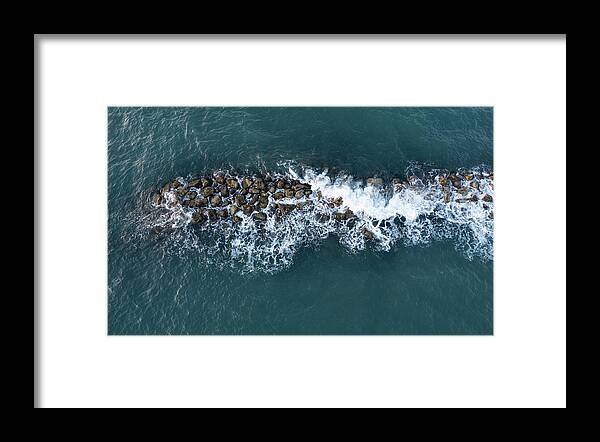 Ocean Framed Print featuring the photograph Aerial view from a flying drone of blue sea water and break water. Sea wall coastline by Michalakis Ppalis