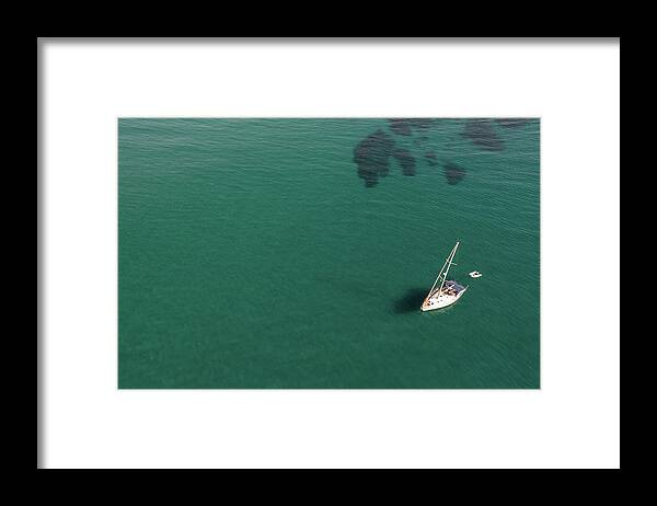 Anchored Framed Print featuring the photograph Aerial view of a luxury yacht anchored in the surface of the sea. Cyprus vacations by Michalakis Ppalis