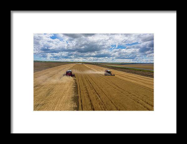 Agriculture Framed Print featuring the photograph Aerial view of combine on harvest field by Mikhail Kokhanchikov
