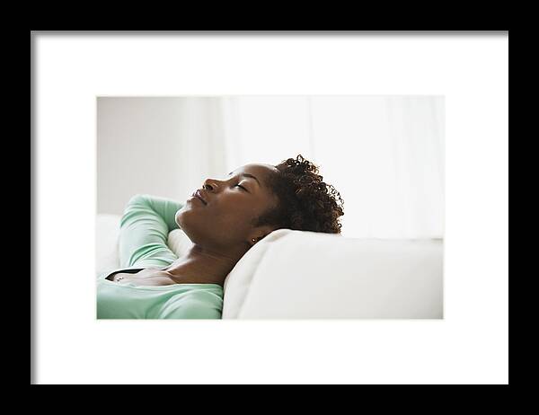 People Framed Print featuring the photograph African woman napping on sofa by Jose Luis Pelaez Inc