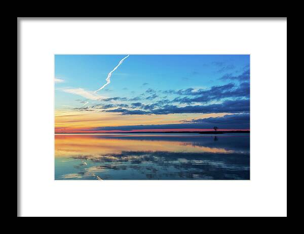 Sundown Framed Print featuring the photograph As the sun goes down on the water by Tatiana Travelways