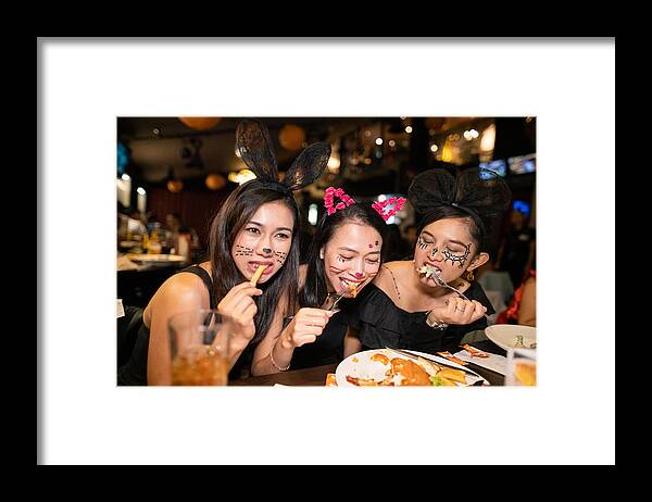 Costume Framed Print featuring the photograph Asian women in halloween costume eating dinner at restaurant together by Satoshi-K