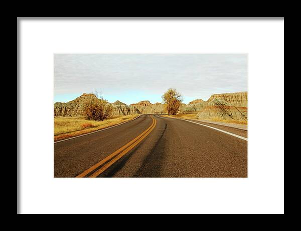 Badlands National Park Framed Print featuring the photograph Badland Blacktop by Lens Art Photography By Larry Trager