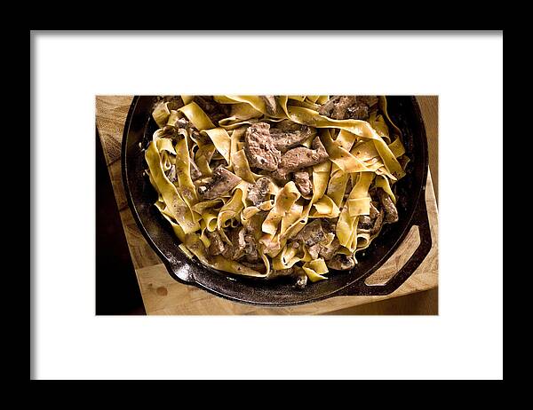 Tenderloin Framed Print featuring the photograph Beef stroganoff in a bowl on a wooden counter by Lara Hata