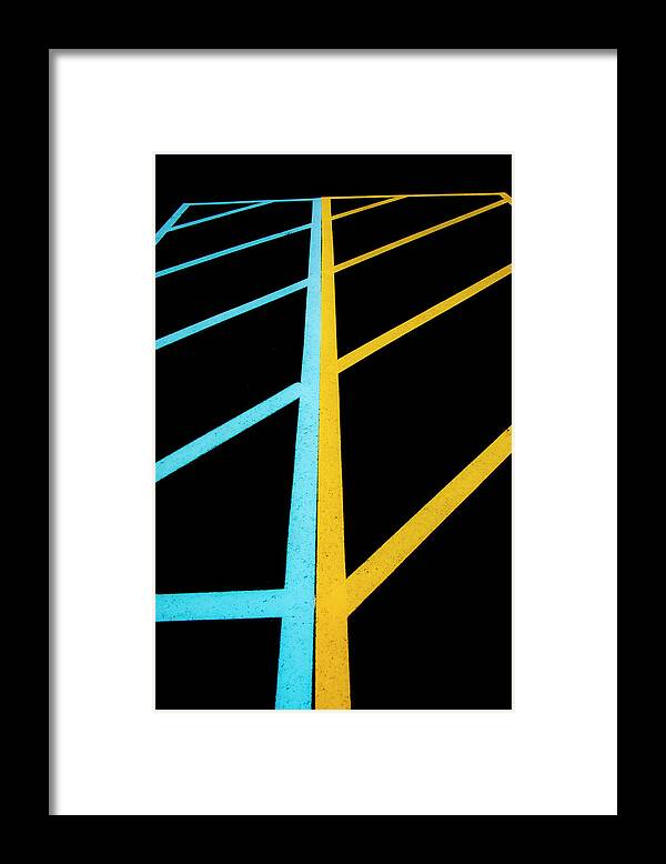 Traffic Lines Framed Print featuring the photograph Blue And Yellow Traffic Lines Meet Along The Boarder by Gary Slawsky