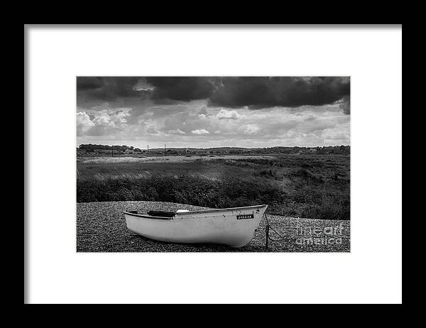 Serene Beached Boat Framed Print featuring the photograph Lonely boat waiting for adventure by Avril Harris