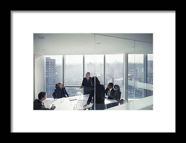 Expertise Framed Print featuring the photograph Business colleagues talking in meeting room by FangXiaNuo
