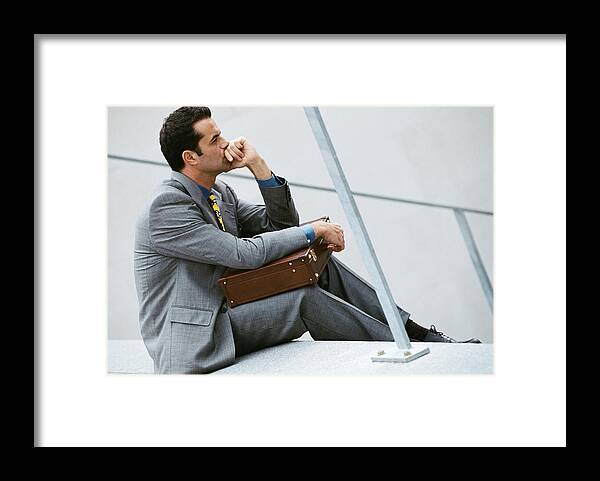 Corporate Business Framed Print featuring the photograph Businessman sitting on stairs, holding briefcase by Eric Audras