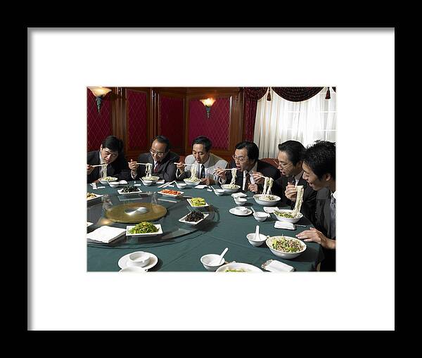 People Framed Print featuring the photograph Businessmen at banquet table eating noodles by Hans Neleman