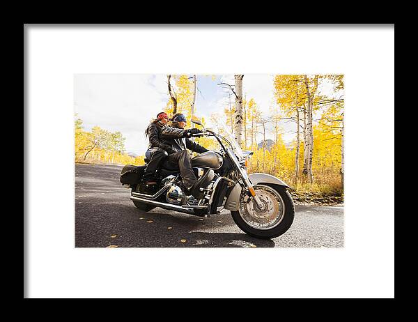 Heterosexual Couple Framed Print featuring the photograph Caucasian couple riding motorcycle by Blend Images - Mike Kemp