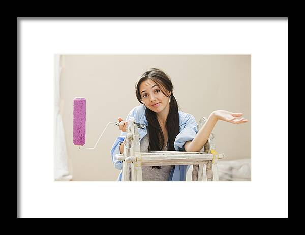 Working Framed Print featuring the photograph Caucasian woman holding paint roller by Mike Kemp