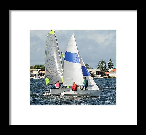 Csne63 Framed Print featuring the photograph Children close racing small sailboats on a coastal lake. by Geoff Childs