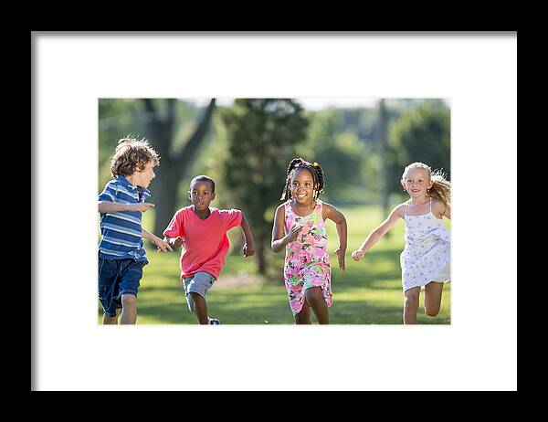 Asian And Indian Ethnicities Framed Print featuring the photograph Children Running Through the Park by FatCamera