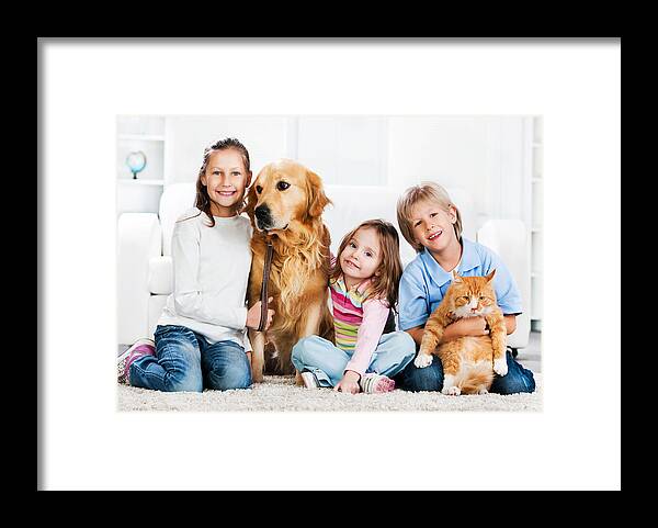 Pets Framed Print featuring the photograph Children with animals sitting on the carpet. by Skynesher