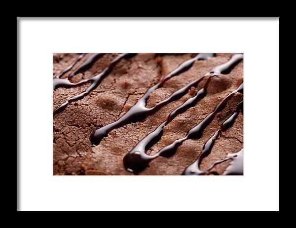 Baked Pastry Item Framed Print featuring the photograph Chocolate sauce drizzled on brownie by Jupiterimages