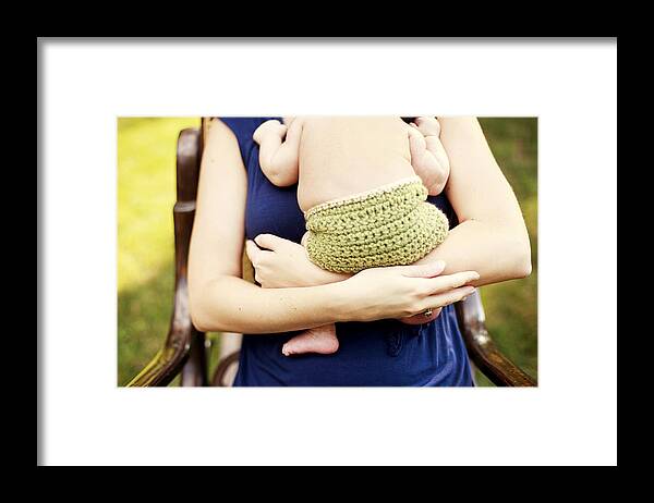 People Framed Print featuring the photograph Close up of girl holding baby in armchair by Shestock